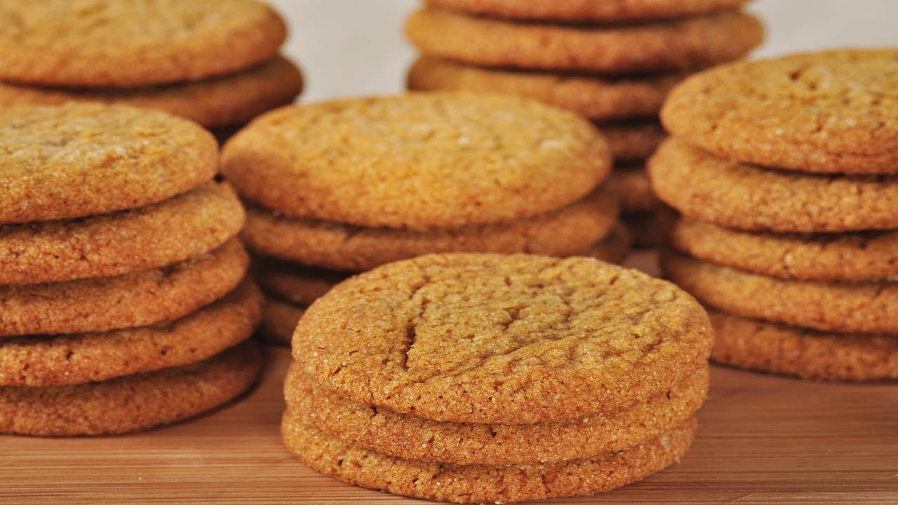 A stack of golden ginger cookies with crackled tops