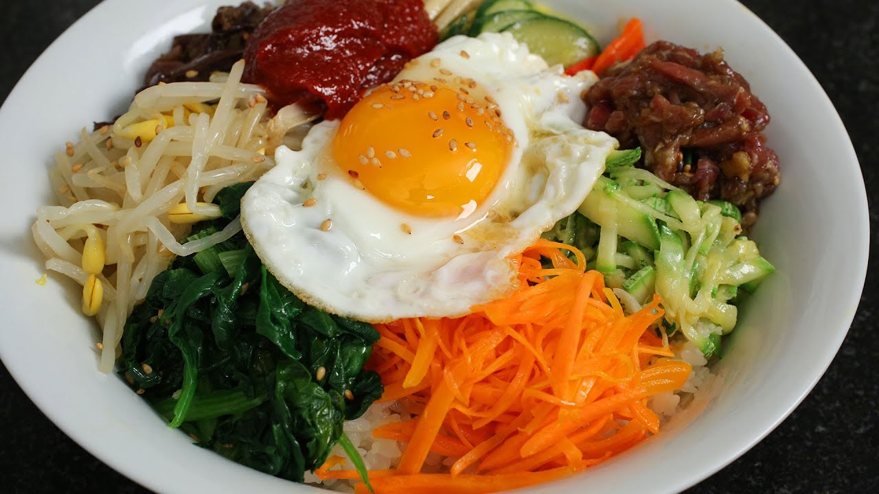Bibimbap with colorful vegetables, rice and an egg